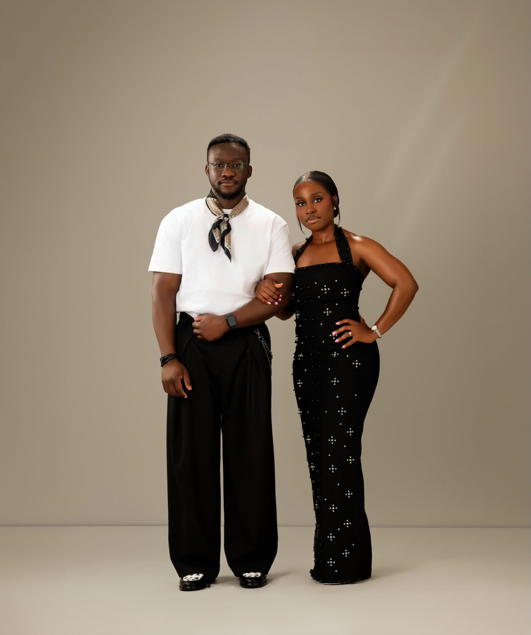 Juwon and Femi standing together in a studio portrait